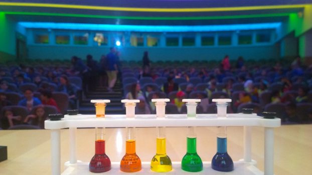 Rainbow liquids in test tubes on stage