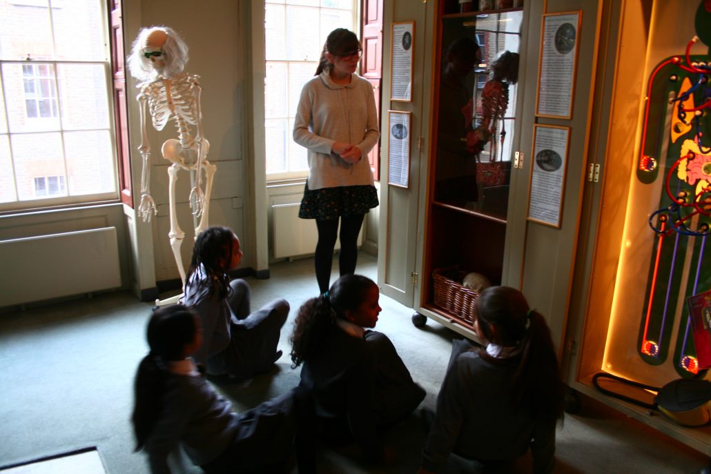 Education volunteer speaking to students in Student Science Centre