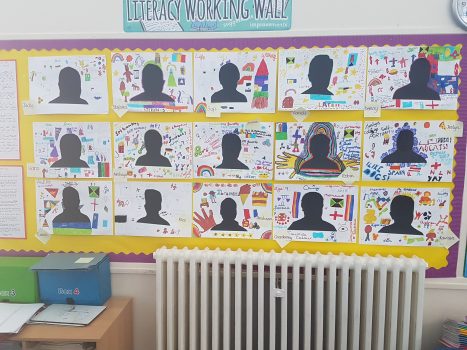 Artworks of portraits on a display board in a primary school