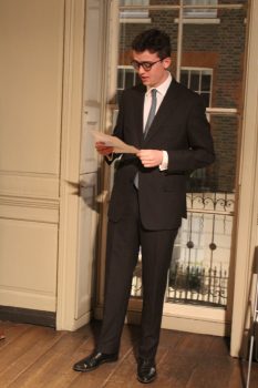 Man giving a talk in Franklin's parlour