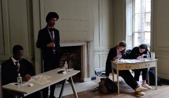 Students in Franklin's parlour at a debate competition