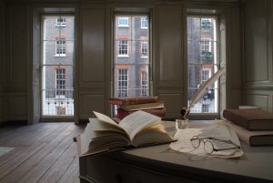Books and bifocals on a desk in Franklin's parlour
