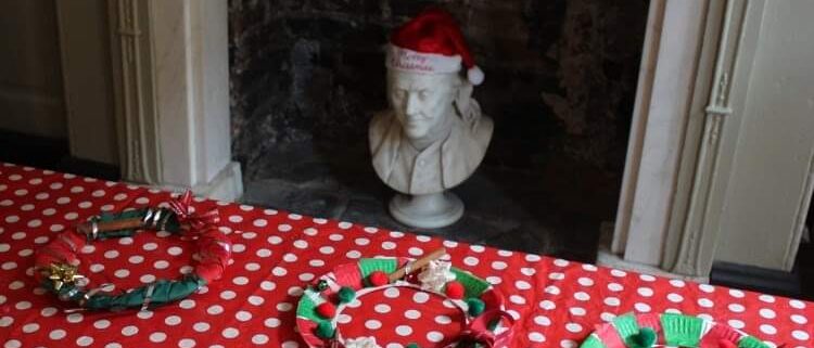 Christmas wreath crafts in Franklin's parlour, decorated for Christmas