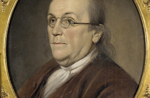 Portrait of Benjamin Franklin, looking off into the distance in a gold frame