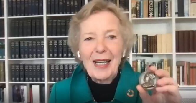 Mary Robinson in a screenshot from a Zoom call, holding up the Benjamin Franklin medal